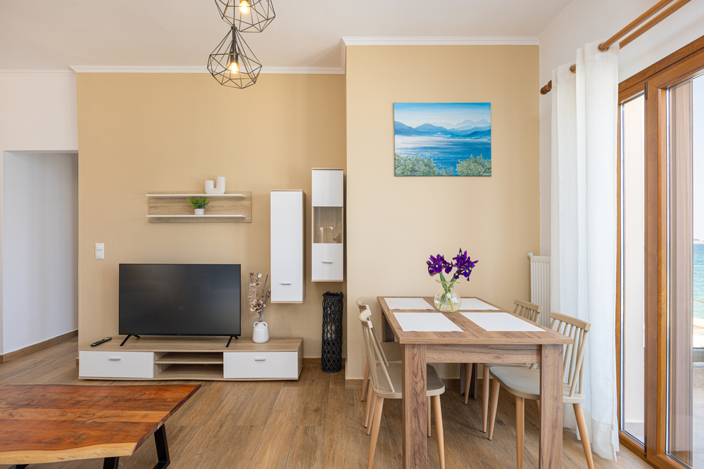 Living and dining area with TV and modern interior at Azzure Studio in Kokkari Samos
