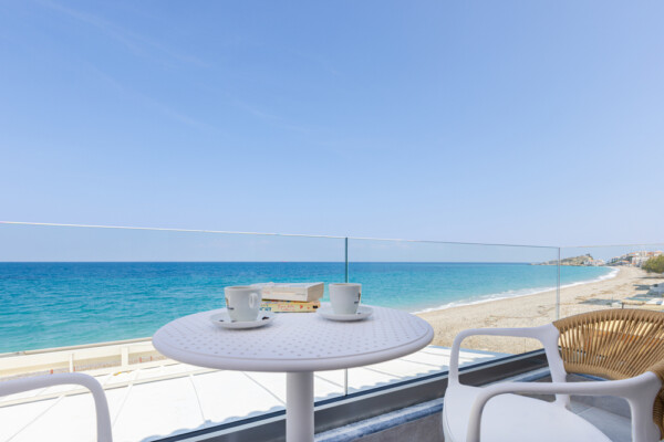 Balcony with coffee table and sea view overlooking Kokkari beach at Azzure Studio in Samos