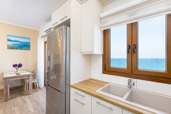 Modern kitchen and dining area with sea view at Azzure Studio in Kokkari Samos