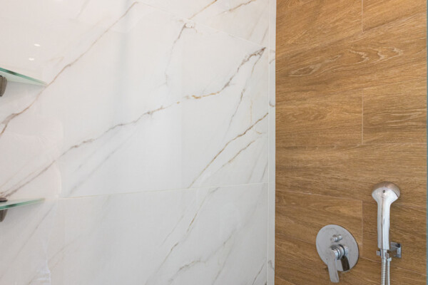 Modern walk-in shower with marble tiles and rainfall showerhead at Azzure Studio in Kokkari Samos