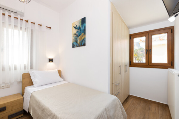 Single bedroom with modern decor and wardrobe at Azzure Studio in Kokkari Samos