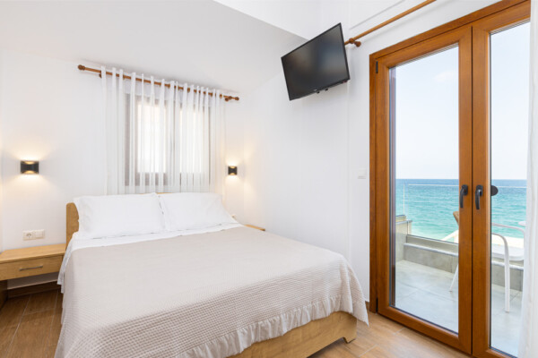 Modern bedroom at Azzure Studio in Kokkari Samos with double bed and balcony overlooking the sea