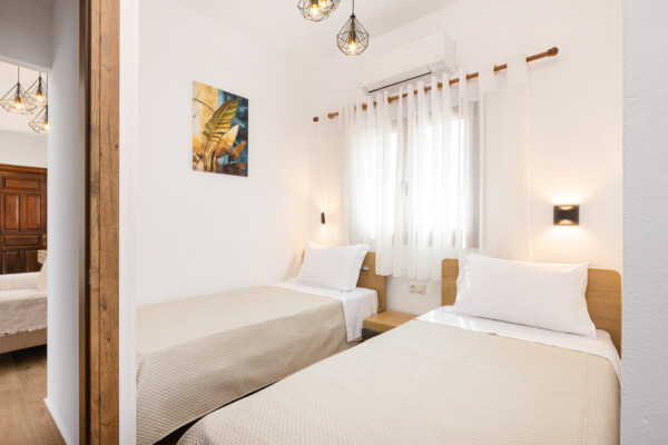Twin bedroom with two single beds and modern decor at Azzure Studio in Kokkari Samos